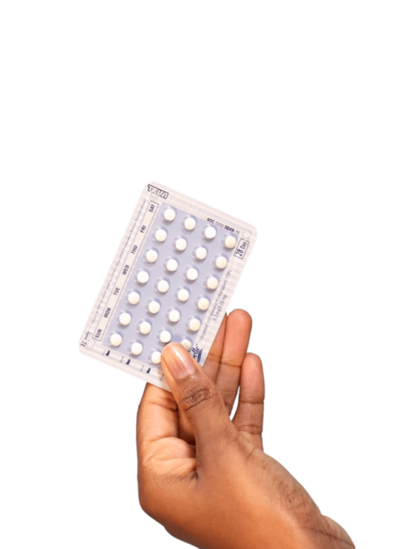A hand holding a blister pack of white pills.