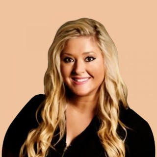 Smiling woman with long blonde hair, wearing a black top, against a beige background.