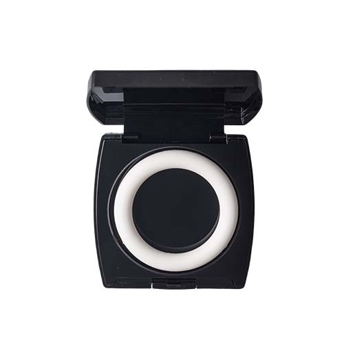 Open black makeup compact with a round white product inside.