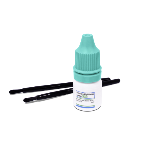 A small plastic bottle with a teal cap sits alongside two black applicator brushes on a white background, perfect for applying Tretinoin Cream.