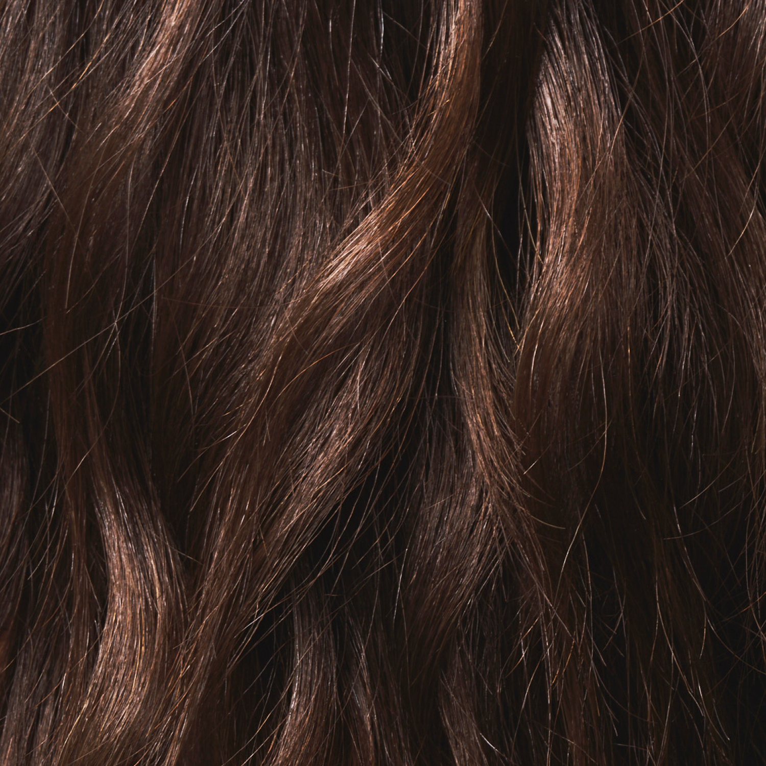 Close-up of wavy brown hair, showing its texture and natural highlights.