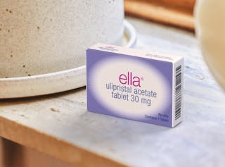 Box of ella ulipristal acetate tablet 30 mg on a countertop beside a ceramic container.