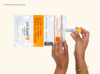 Hands gently cradling a specimen vial and a labeled LabGuard specimen bag on a plain background, prepared for UTI testing.