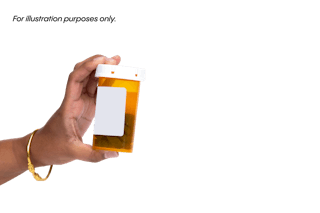 A hand holding an amber prescription pill bottle with a blank white label against a plain background.